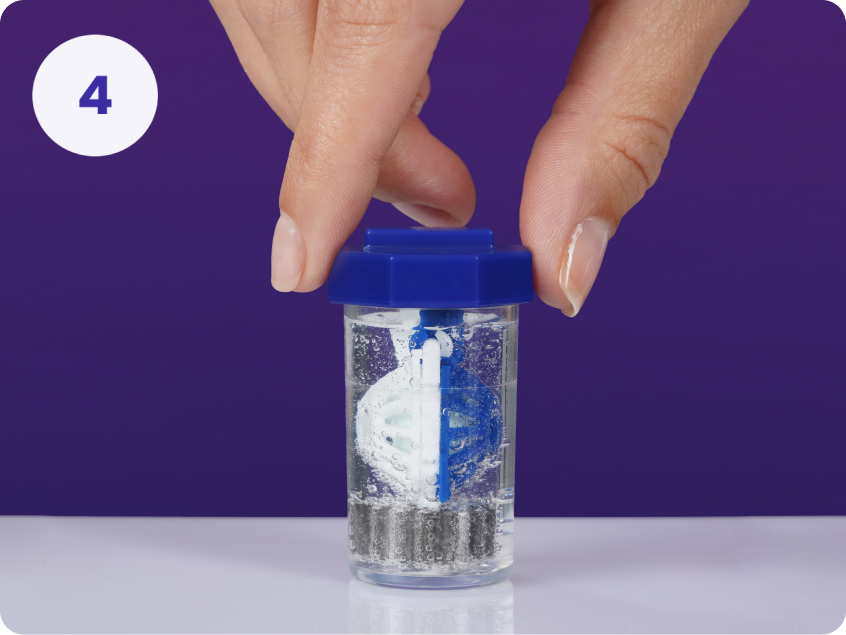 Number 4 - hand screwing the lid of contact lens case into place submerging basket in bubbling hydrogen peroxide contact solution liquid