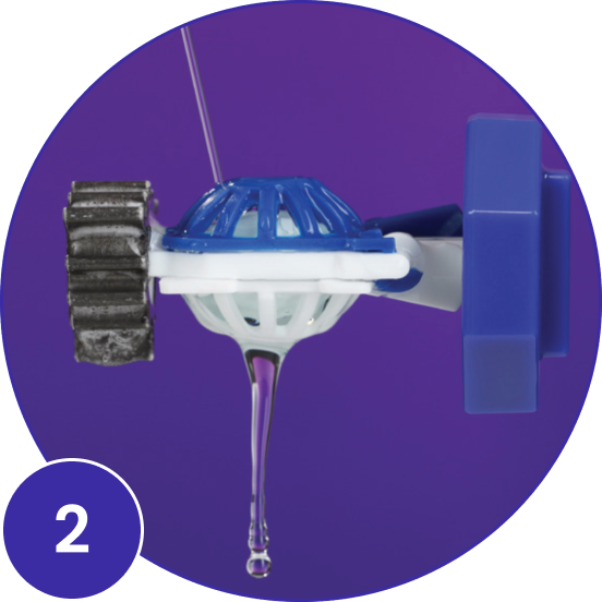 Number 2 - contact lens hydrogen peroxide solution applied to top of lens basket with solution dripping from the bottom of basket