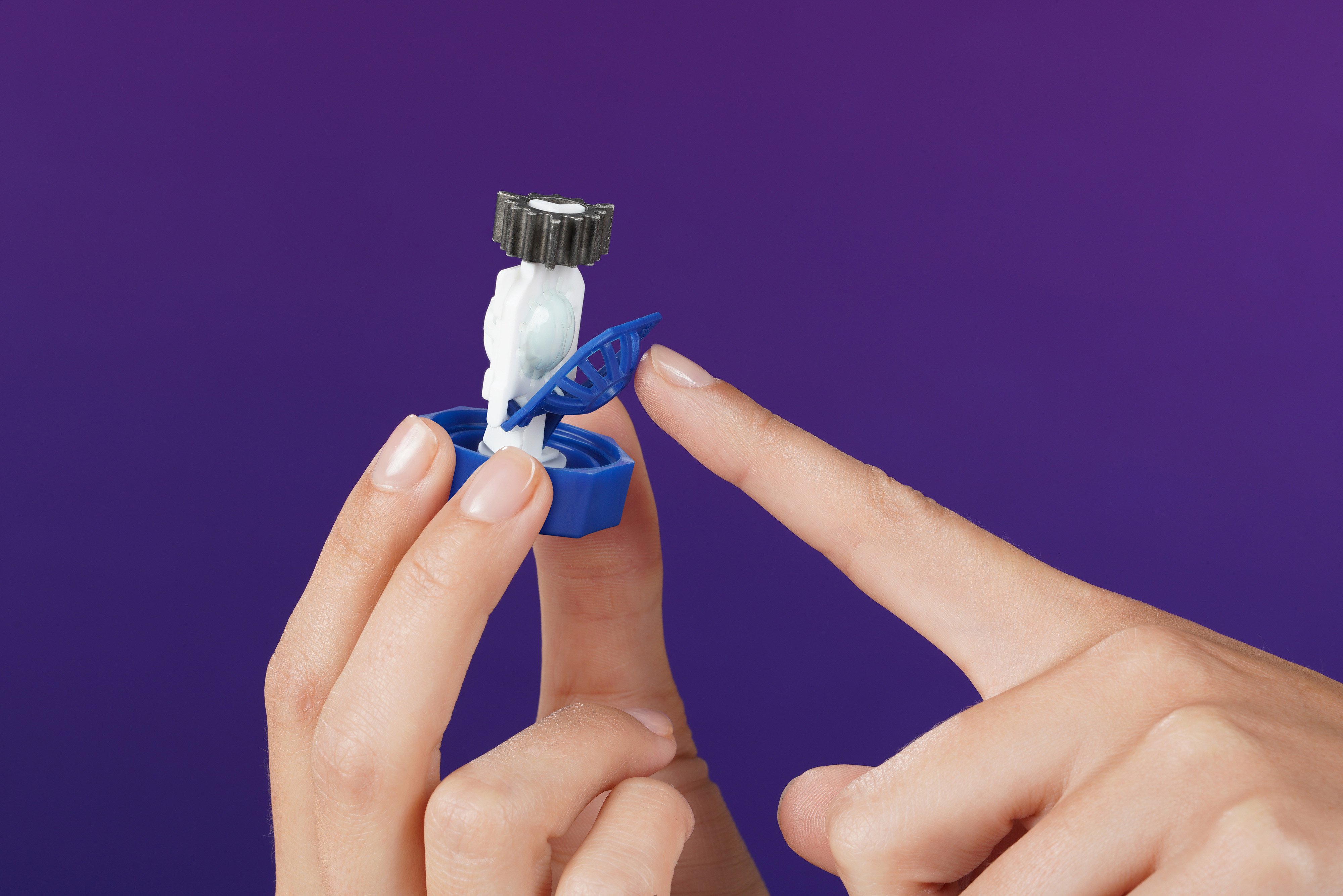 Number 2 - hand holding contact lens case lid pointing at open lens basket